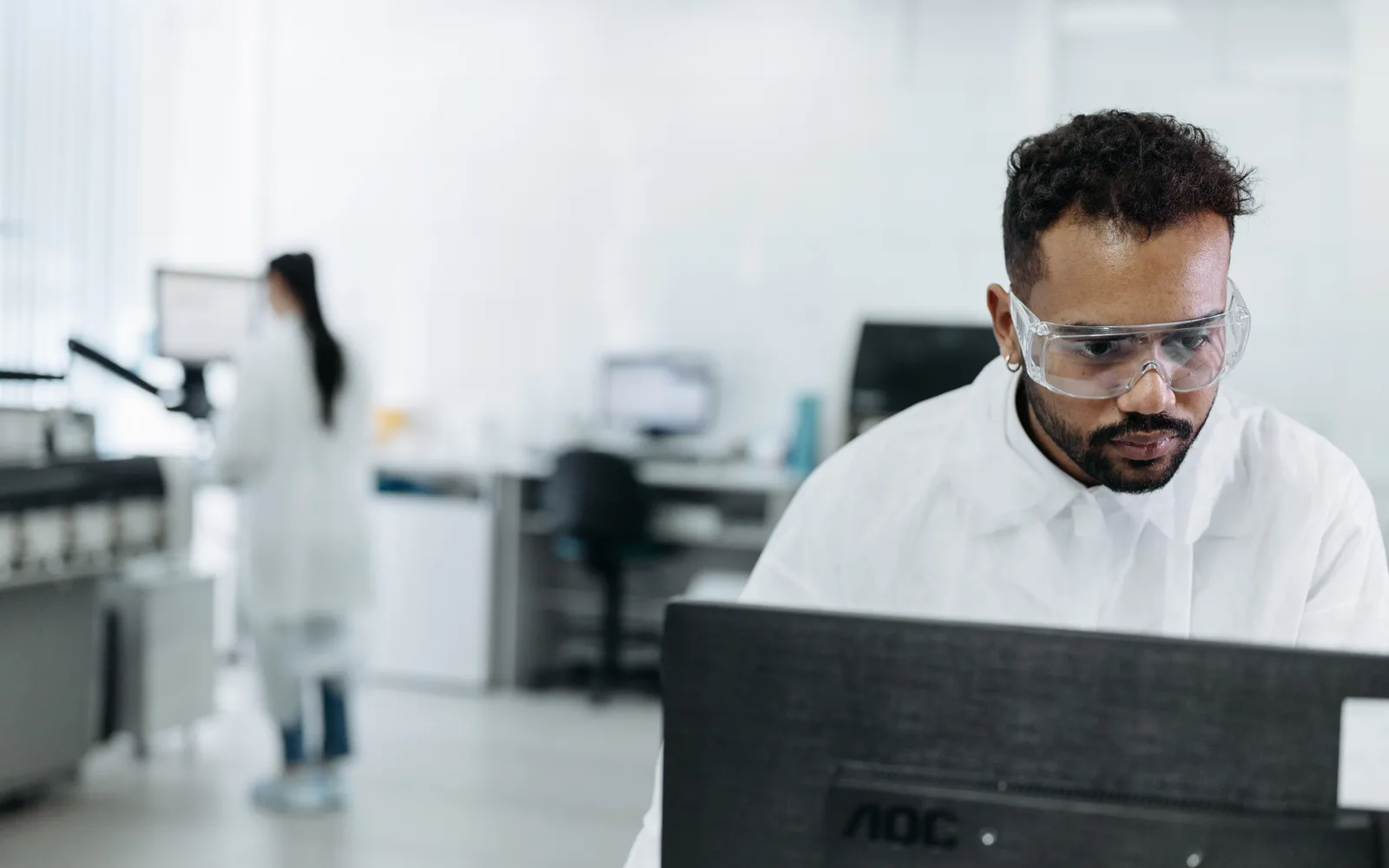 Researcher wearing goggles in a laboratory
